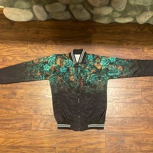 Zip up jacket, size medium, different shades of greens and brown white and black